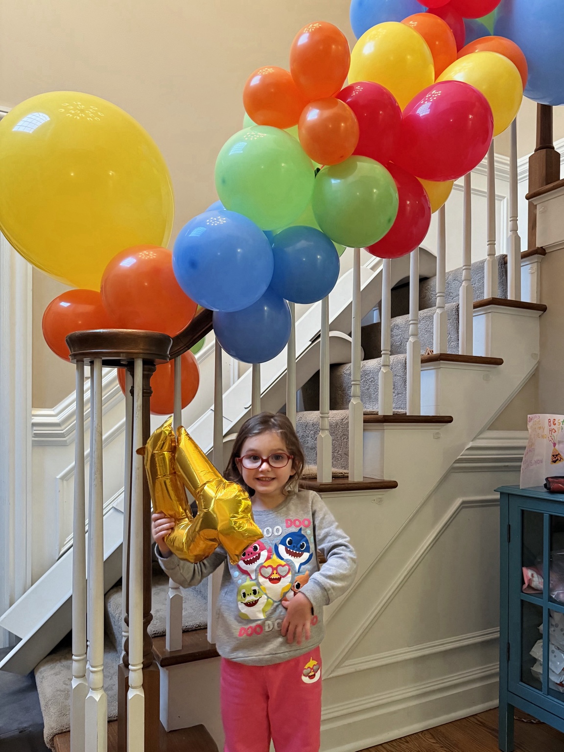 Lizzie celebrating with colorful balloons